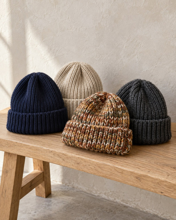 Knit beanies on a wooden bench